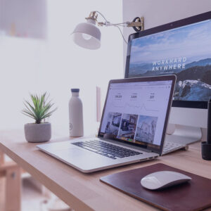 desk with a laptop and screen